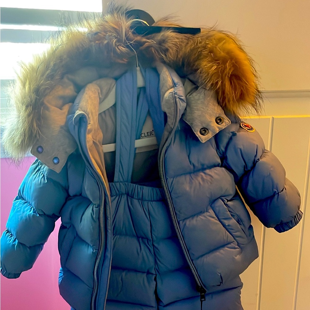 This is a powder blue infant Moncler snowsuit